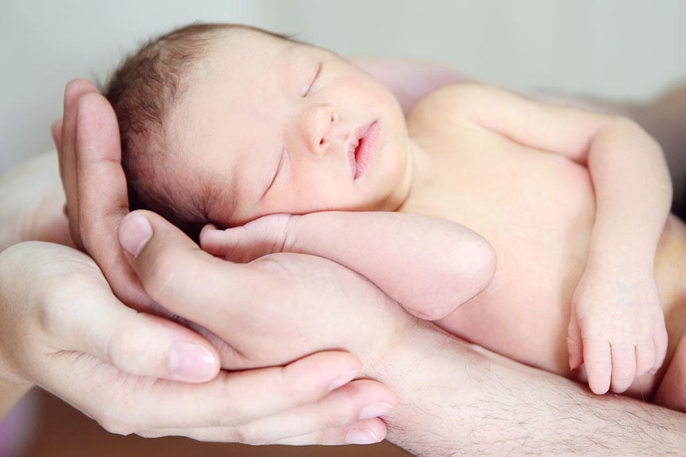 Newborn baby in parents hands