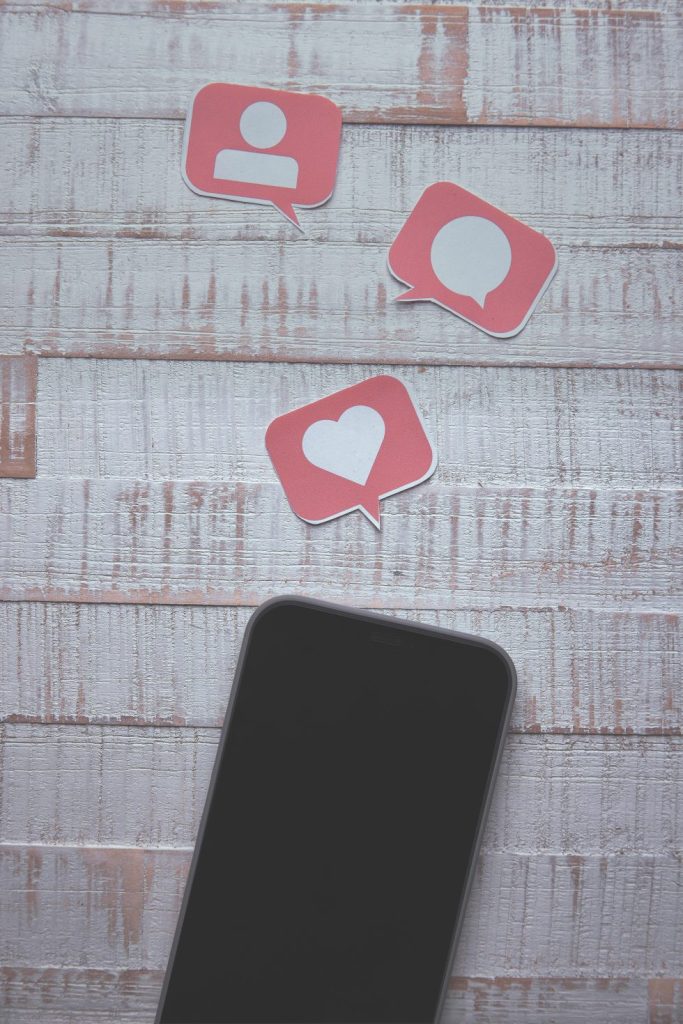 smartphone lies on a white wooden surface
