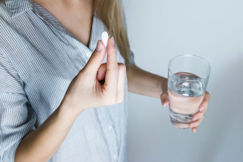 Woman holding pill