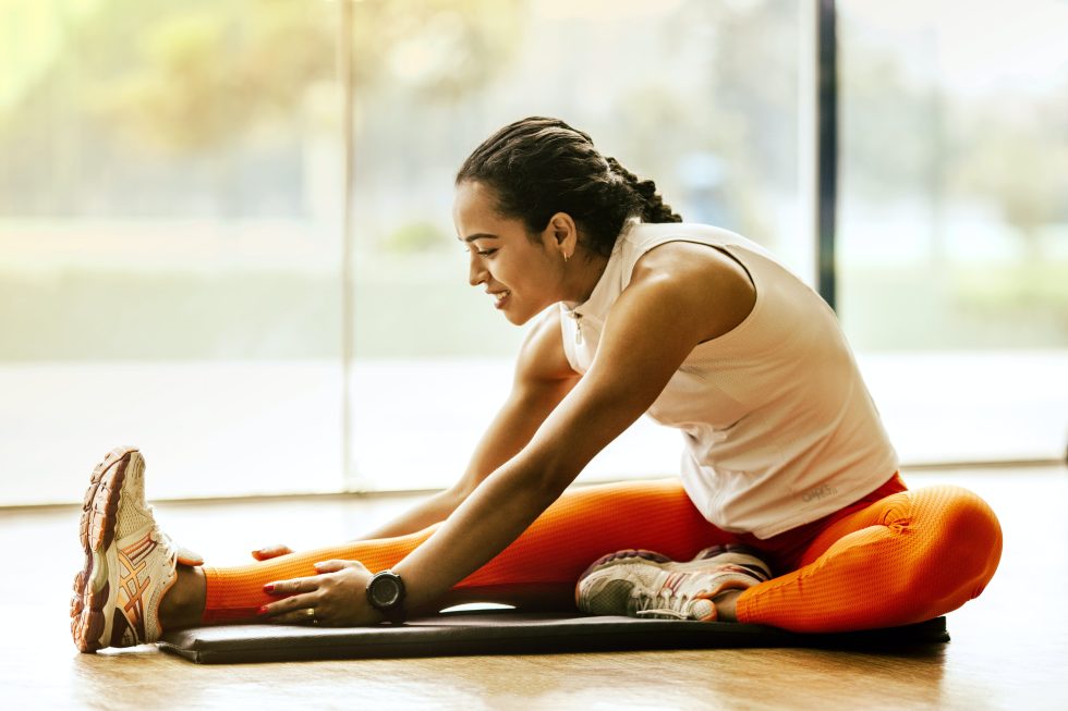 Woman stretching indoors