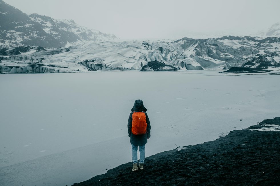 Hiker near glacier lake
