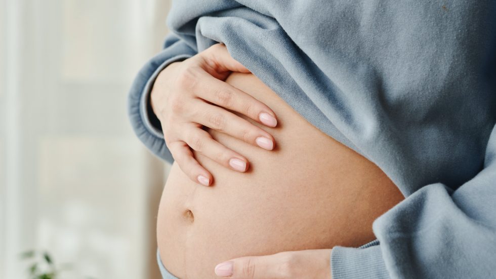 Hands on pregnant bellyT
