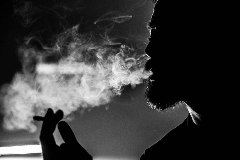 Man smoking in shadow